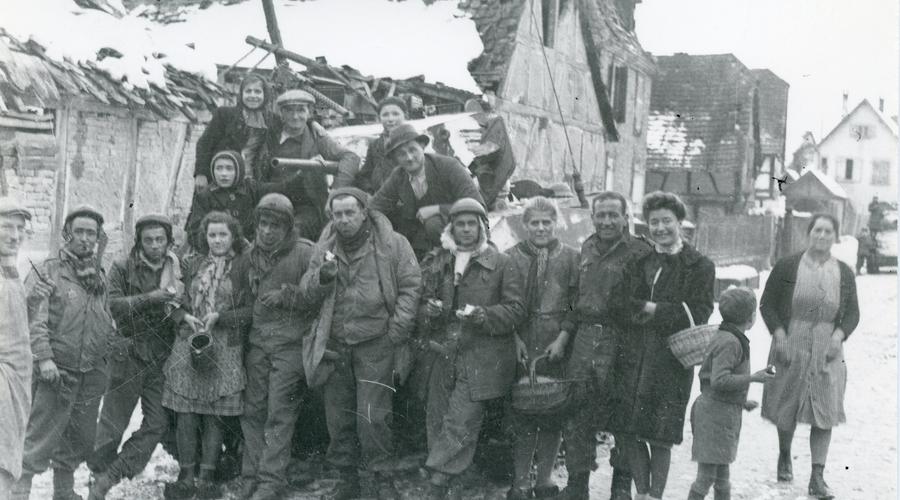 Les habitants de Sélestat ont réservé un accueil chaleureux aux soldats américains ; ils posent devant leur char dans un quartier en ruines. 