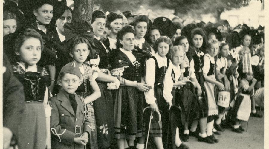 Les habitants de Sélestat, fièrement vêtus du costume traditionnel alsacien, assistent au défilé du 14 Juillet. 